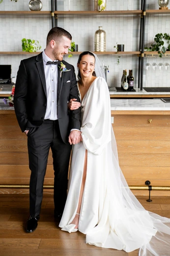 Wedding cakes and tall floral display by a window