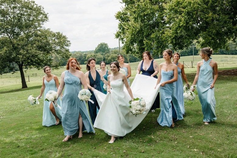 Wedding party laughing together outdoors