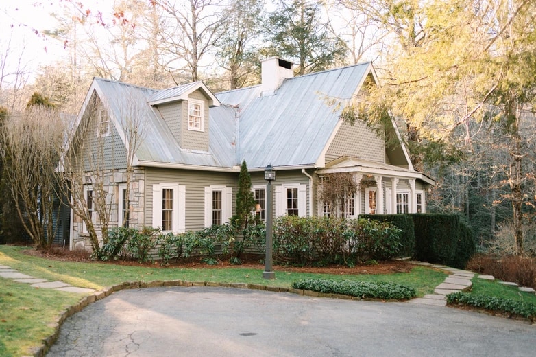 Rustic cottage-style wedding venue surrounded by trees